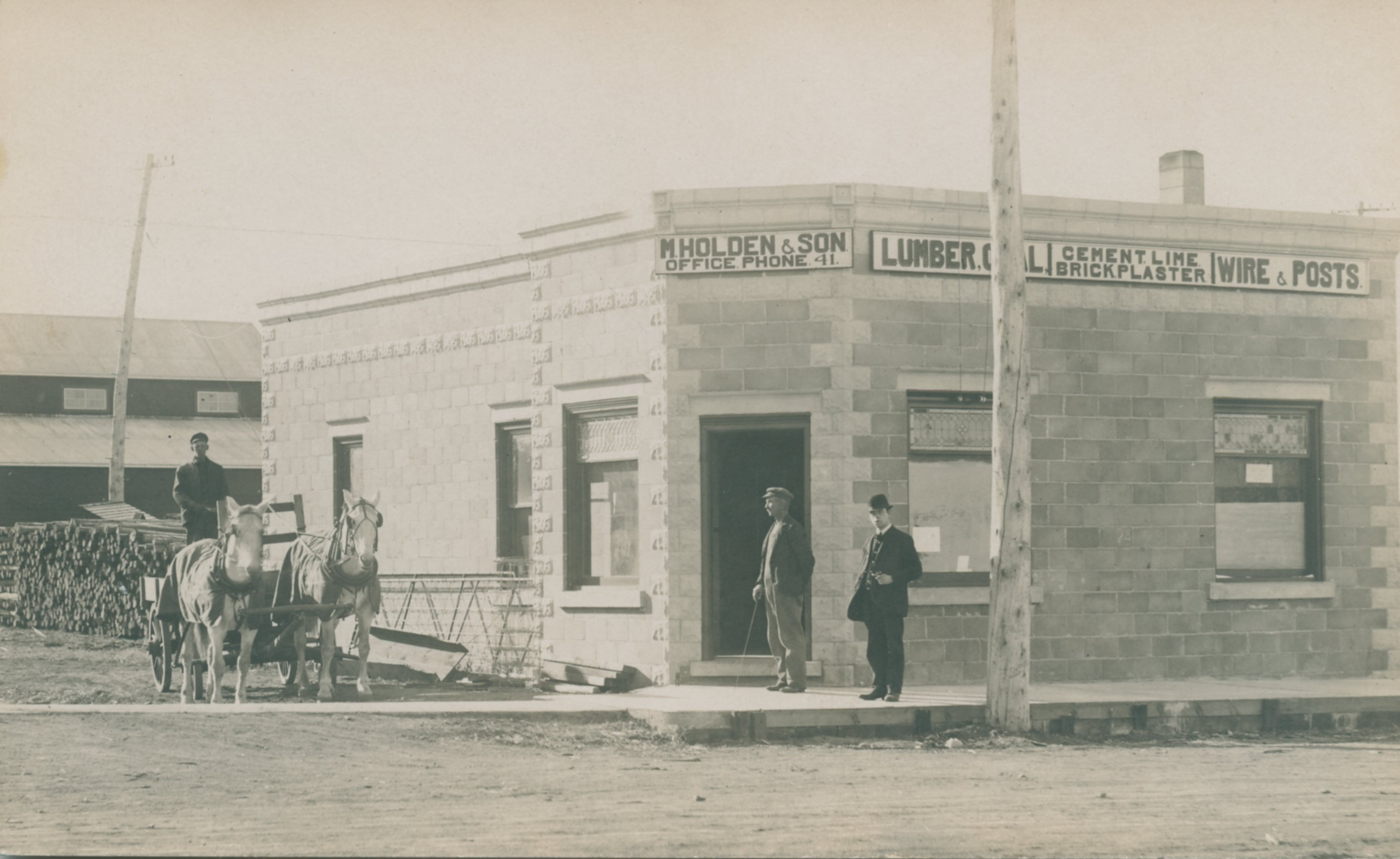 [Scanned photo of M Holden and Son building at the intersection of Cherry Street and South Railway]