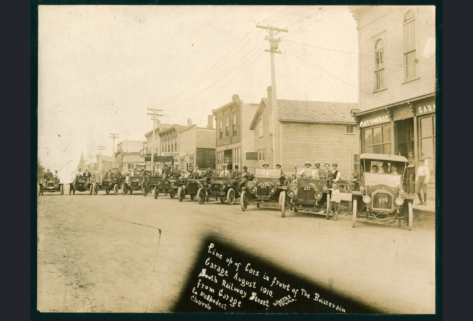 [Scanned photo of the Boissevain Auto Club along the south side of South Railway in August 1910 looking east]