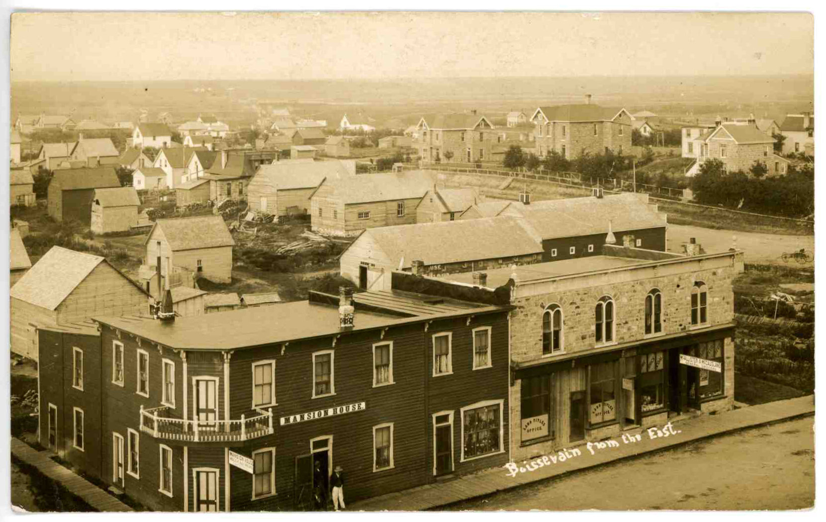 [Scanned photo of an elevated view of the Mansion House at the intersection of South Railway and Johnson Street with a view of buildings to the Southwest]